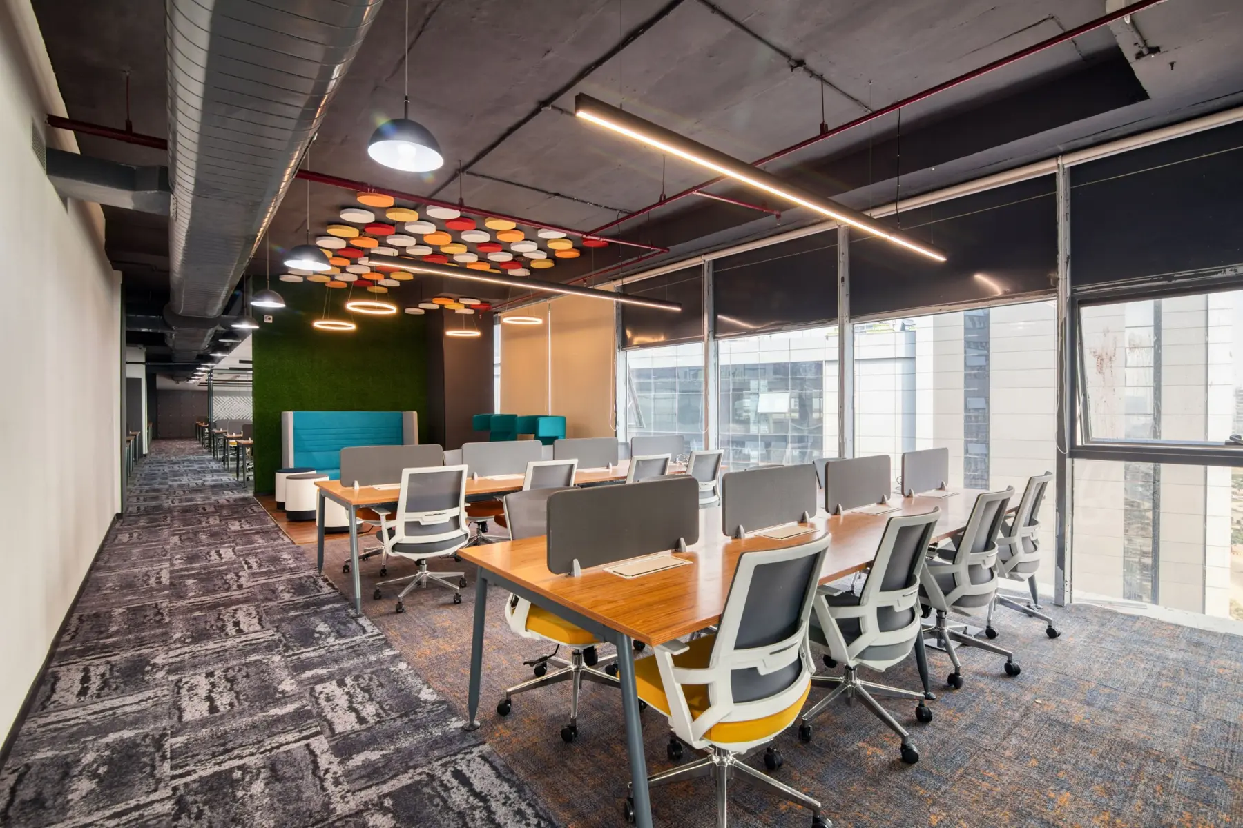 Open-plan office with desks by large windows