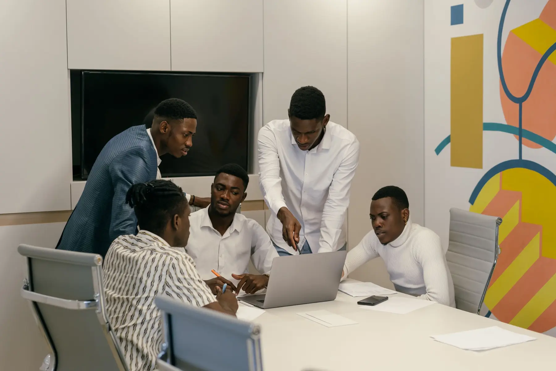 Engineers gathered around a laptop